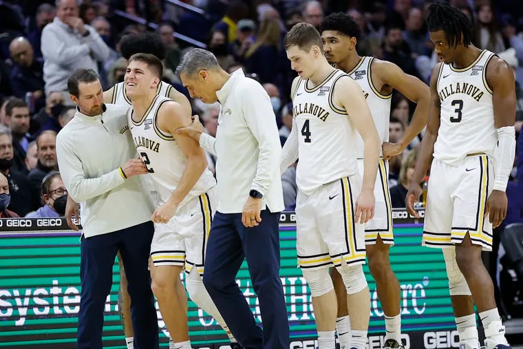 Villanova guard Collin Gillespie gets help walking off the court after injuring his leg during the second half against Connecticut on Saturday.