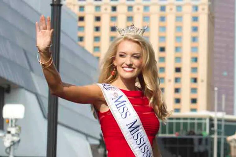 Tuesday September 3, 2013. With the arrival of the contestants the Miss America Pageant officially returns to Atlantic City. Here,Chelsea Rick, Miss Mississippi waves to the crowd on the AC boardwalk. ( ED HILLE / Staff Photographer )