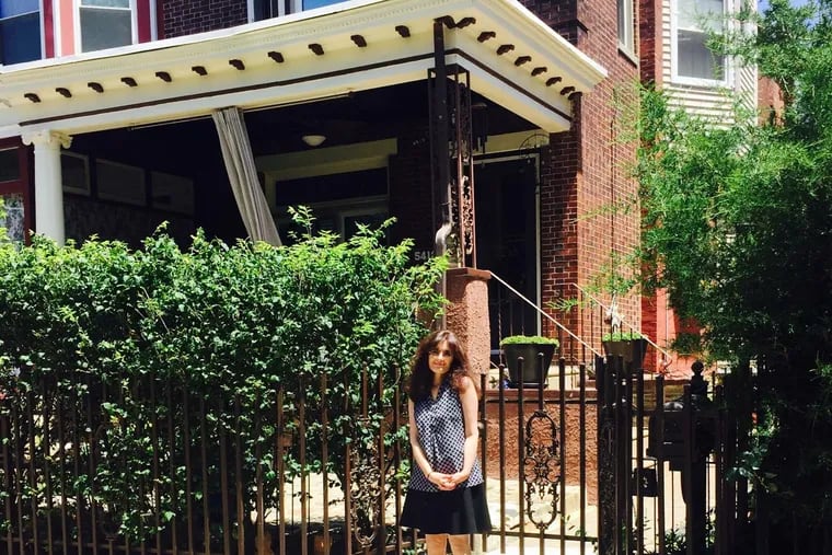 Columnist Christine Flowers poses in front of her childhood home.