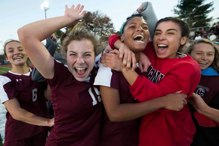 Conestoga's Nia Scott (center) is mobbed by teammates after scoring the game-winning goal in overtime in the PIAA District 1 Class 4A girls' soccer championship against Souderton Saturday, November 3, 2018.