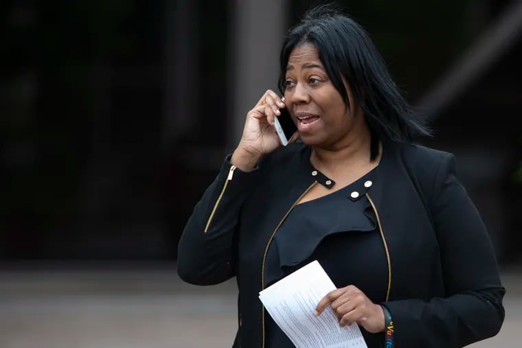 Saudia Shuler, also known as "Camel Prom Mom," speaks on the phone while she exits the federal courthouse Wednesday in Philadelphia after her sentencing on government disability fraud charges. Shuler was ordered by a judge to serve six months' house arrest and three years' probation.