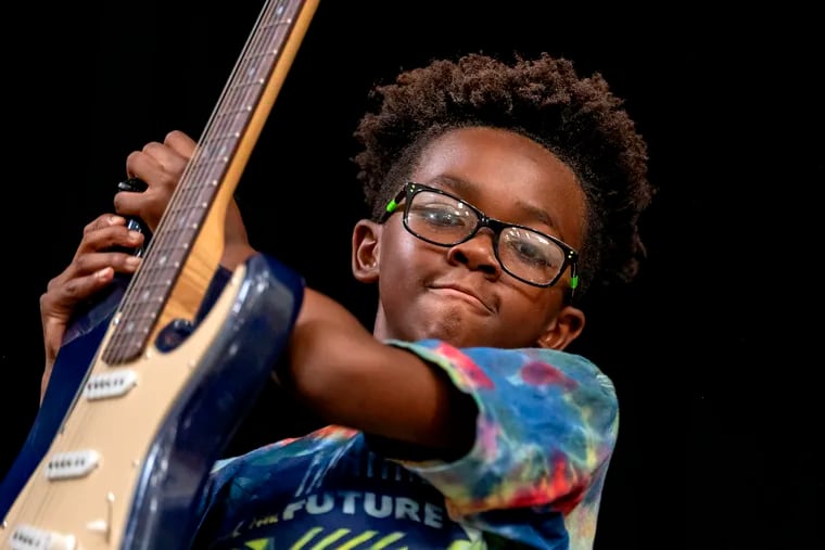 Brian Jackson ending his set as Rock to the Future kids celebrate during Germantown Summer Showcase at Roosevelt Elementary School.