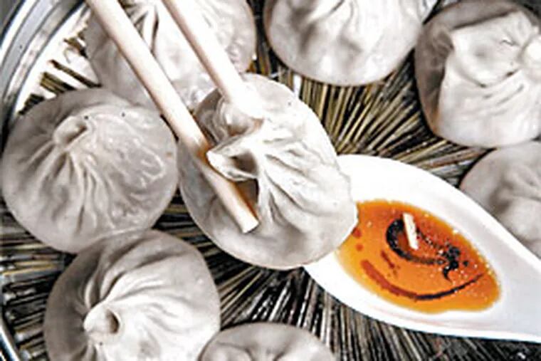 The &quot;soup dumplings&quot; - or &quot;Shanghai steamed buns&quot; - are an adventure diner&#0039;s dream, although eating them without being scalded is a challenge. (BARBARA L. JOHNSTON / Inquirer)