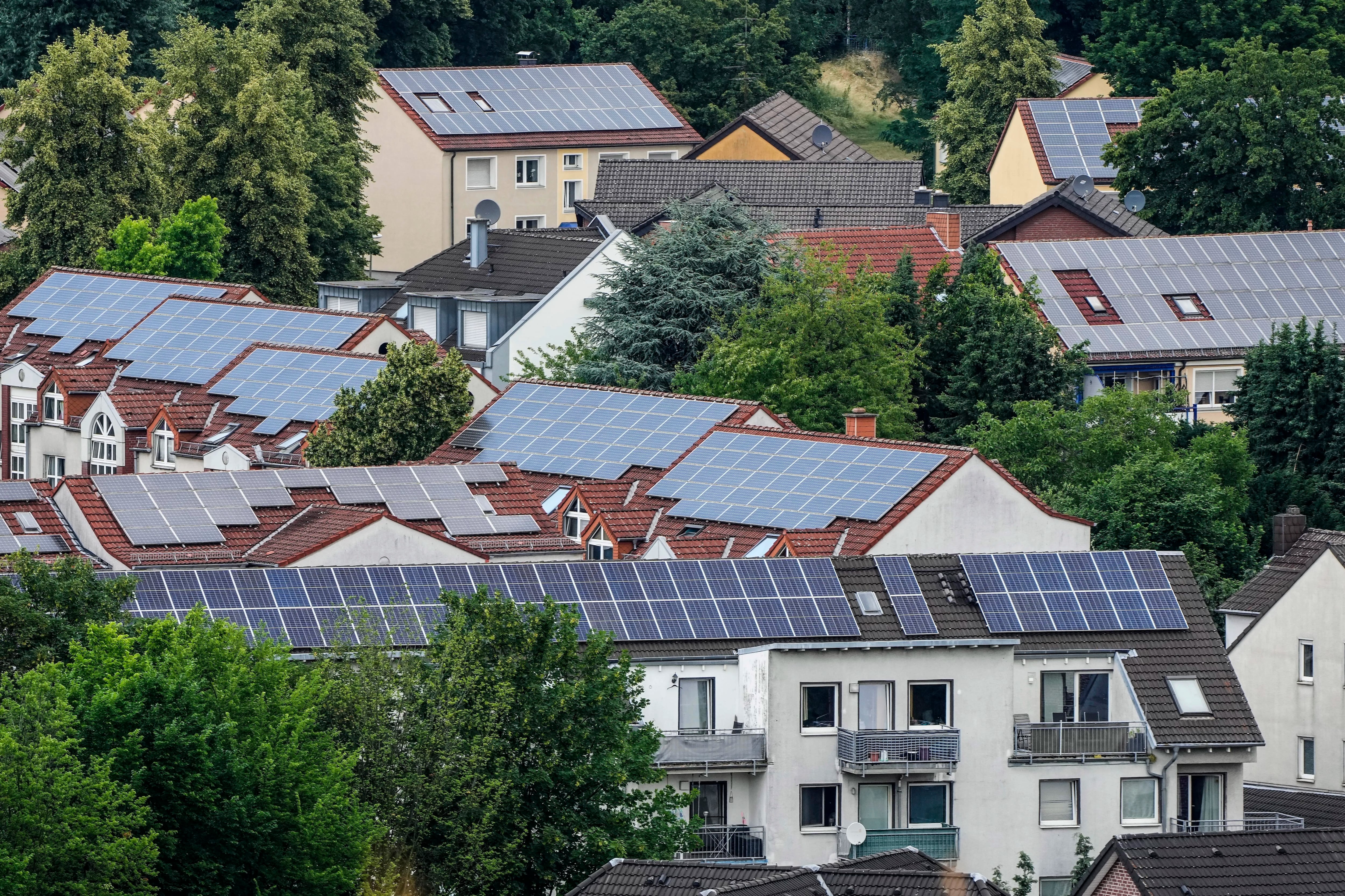 Solar panels are mounted on the roofs of apartment buildings in Bottrop, Germany, June 26, 2023. The world's renewable energy grew at its fastest rate in the past 25 years in 2023, the International Energy Agency reported Thursday, Jan. 11, 2024.