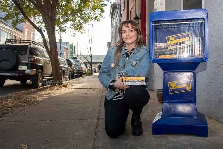 Kim Lettiere with the Free Blockbuster she put up on East Columbia Avenue near Girard Avenue in Fishtown.