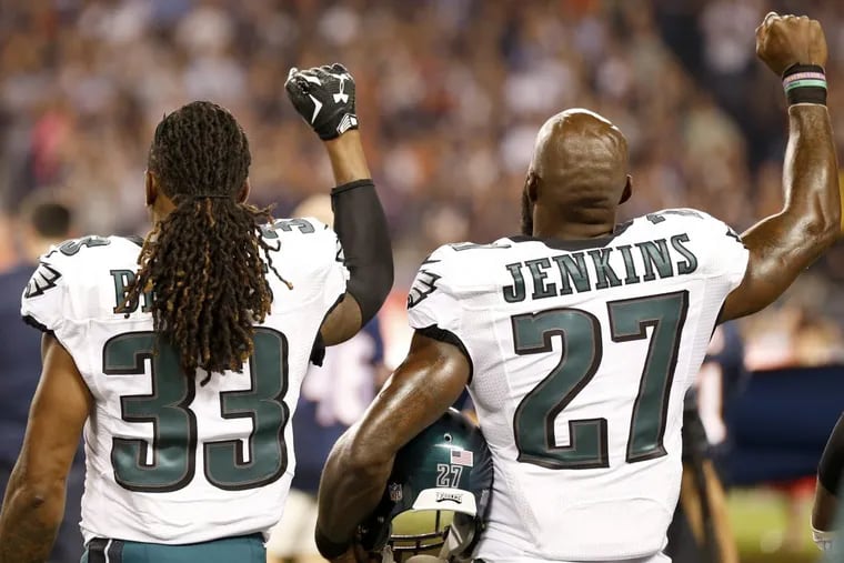 Malcolm Jenkins and defensive back Ron Brooks raise their fists during the national anthem before the Eagles played the Bears in Chicago last season.