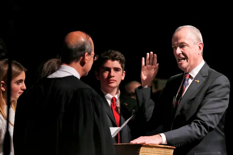 In this Jan. 16, 2018, file photo, Gov.-elect Phil Murphy, right, takes the oath of office during a ceremony in Trenton, N.J. New Jersey was one of 40 states with a general fund surplus in fiscal year 2018.