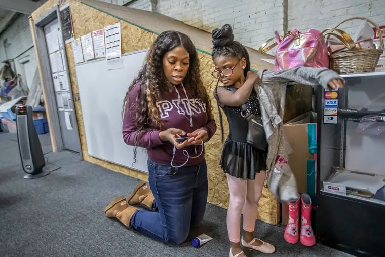 Menda Stewart, left, a nurse and mother of McKenzie Stewart, 6, right, who was diagnosed with type 1 diabetes when she was 4, checks McKenzie’s  blood sugar levels before allowing her to begin her first of three dance classes at the Eleone Dance Unlimited studios.