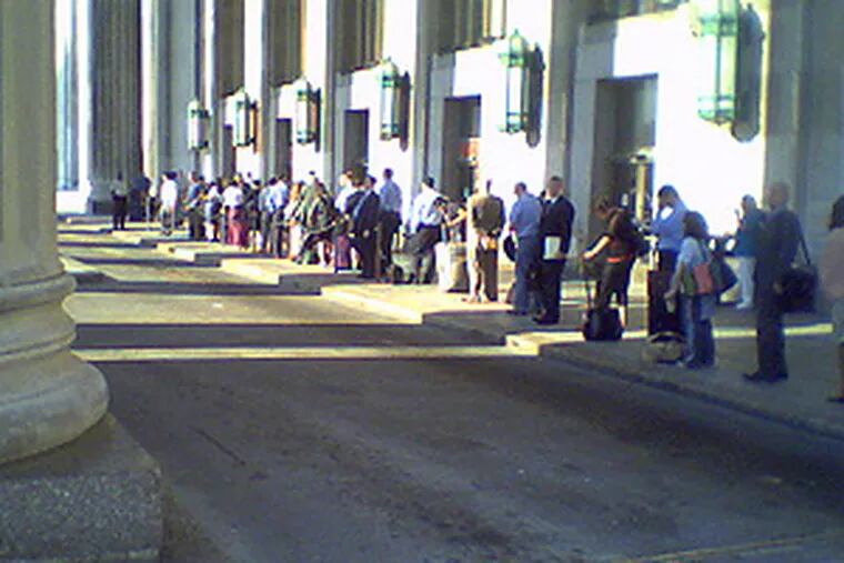 Commuters and visitors wait for cabs at 30th Street Station. As trains arrived, long lines would form, then steadily shorten, as people found rides with non-striking taxis and limousines.