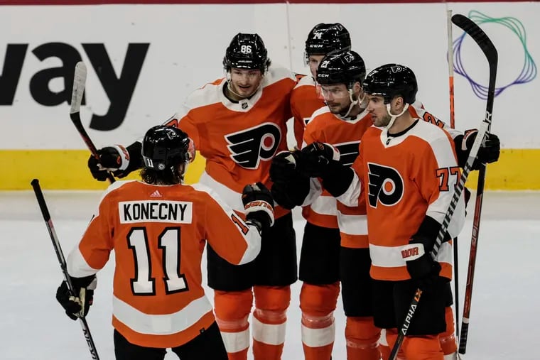 Flyers Scott Laughton second from right celebrates his power play goal against the Capitals with teammates during the first period at the Wells Fargo Center in Philadelphia, Wednesday, January 11, 2023.