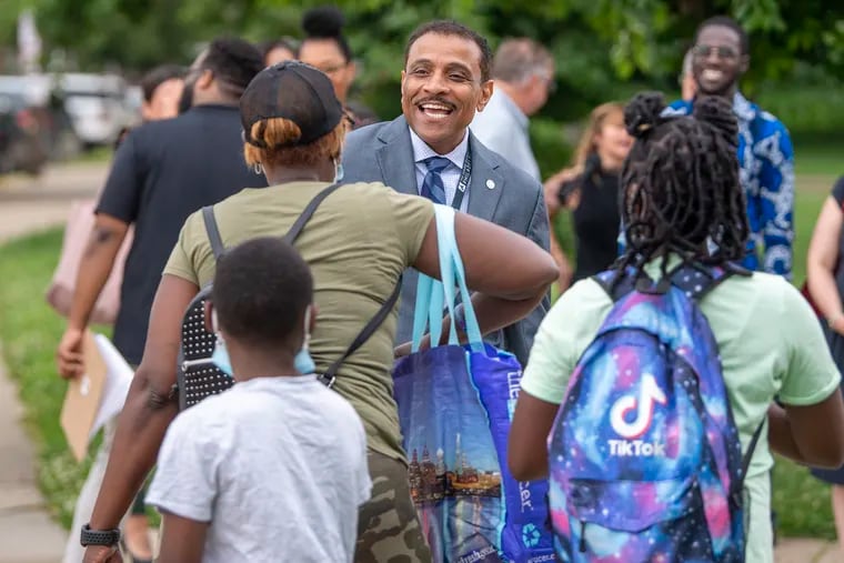 Philadelphia School District Superintendent Dr. Tony Watlington, Sr., greets Catina Hopson with her kids Taylor Hopson and Jahseen Morrison, left, on Monday, June 27, 2022., during the first day of summer school at the Locke Elementary School in West Philadelphia, Pa.