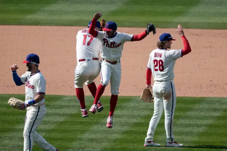 The Phillies celebrate after sweeping the Atlanta Braves with a 2-1 win over the Atlanta Braves on Easter Sunday.
