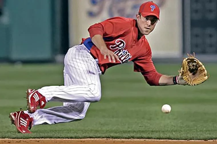 Chase Utley makes a play on Pirates' Jeff Clement last night at Citizens Bank
Park. (Steven M. Falk / Staff Photographer)