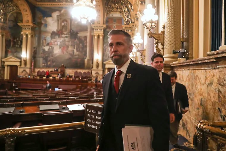 Pa. State Rep. Craig Williams (R-Chester) holds the articles of impeachment against Philadelphia District Attorney Larry Krasner as he leaves the House Floor at the State Capitol in Harrisburg on Wednesday. Behind Williams is State Rep. Jared Solomon (D-Phila). The articles were then formally delivered to the State Senate.