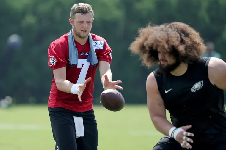 Nate Sudfeld takes a few extra snaps with Isaac Seumalo on Monday at the NovaCare Complex.