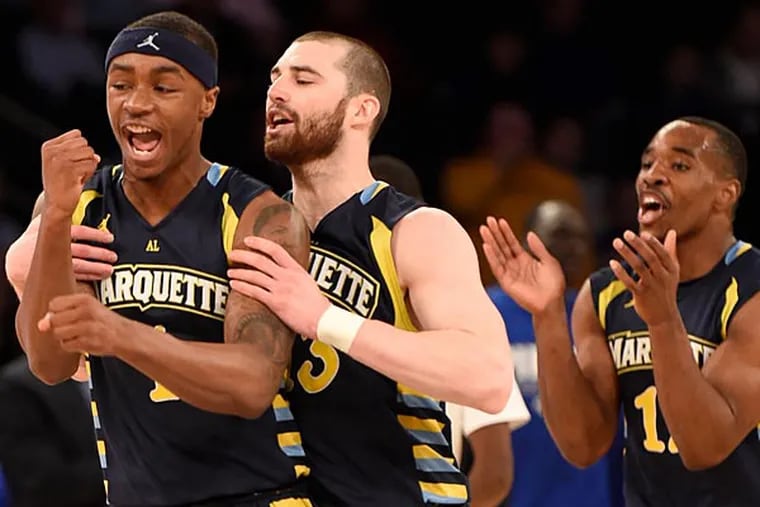 Marquette Golden Eagles guard Duane Wilson (1) and guard Matt Carlino (13) celebrate a three point basket against the Seton Hall Pirates during the first round of the Big East Tournament at Madison Square Garden. (Robert Deutsch/USA Today)