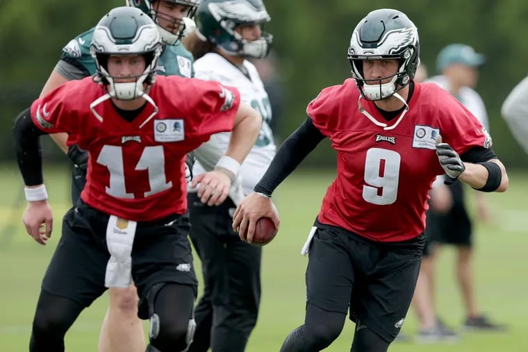 Eaglesâ€™ Carson Wentz, left, and Nick Foles, right, warm up as the Eagles hold OTA's at the NovaCare Complex in Philadelphia, PA on May 29, 2018. DAVID MAIALETTI / Staff Photographer