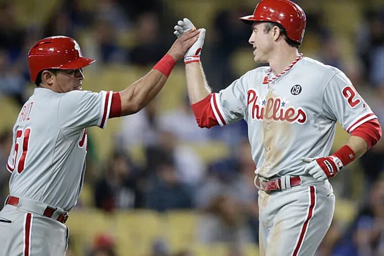 Chase Utley, right, and Carlos Ruiz celebrate after they scored on a single hit by Marlon Byrd during the ninth inning of a baseball game against the Los Angeles Dodgers on Thursday, April 24, 2014, in Los Angeles. (Jae C. Hong/AP)