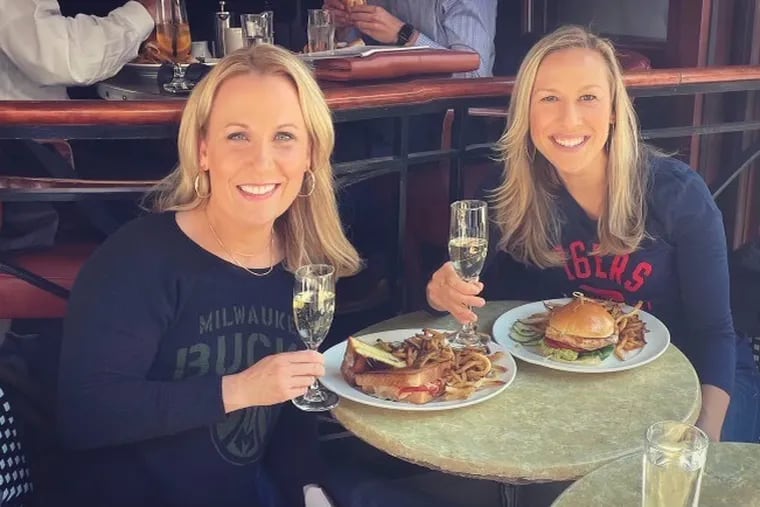 Kate Scott, right, and Lisa Byington have dinner. Their historic hirings as play-by-play announcers for the Sixers and Milwaukee Bucks, respectively, were announced within days of each other last fall.