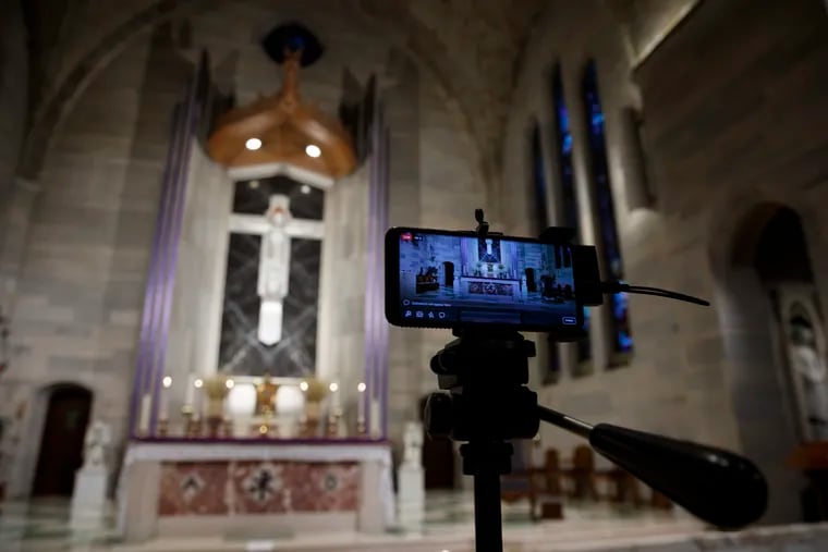 A smartphone is used to livestream a Eucharistic Adoration service at Saint Ann Catholic Church in Washington, during the coronavirus pandemic.