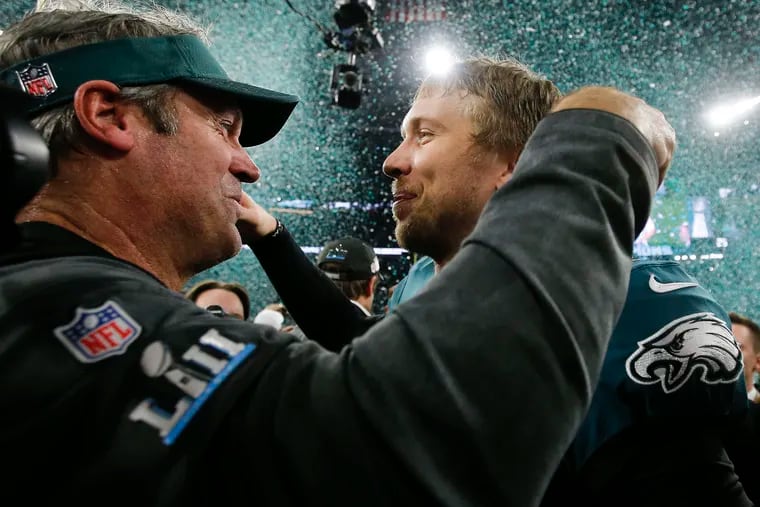 Eagles head coach Doug Pederson and Eagles quarterback Nick Foles celebrates after beating the New England Patriots for the Super Bowl LII title on Sunday, February 4, 2018 in Minneapolis.