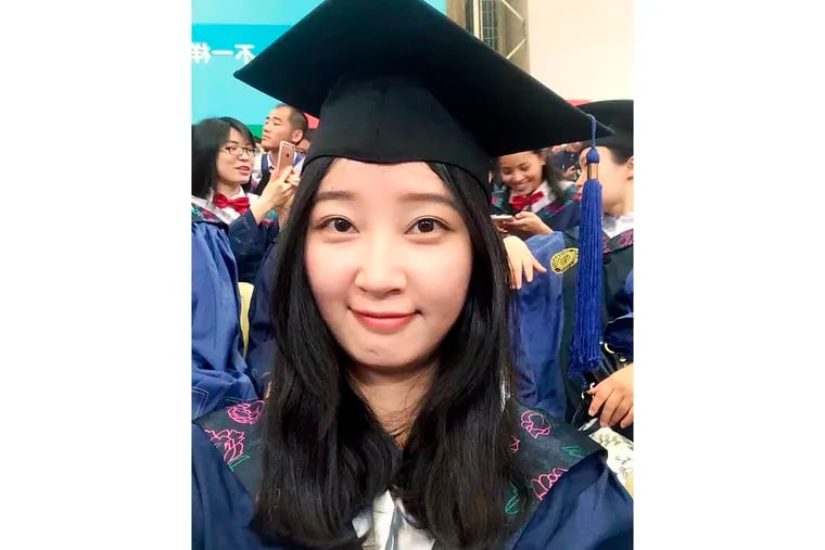 FILE - This 2016 selfie provided by her family shows Yingying Zhang in a cap and gown for her graduate degree in environmental engineering from Peking University Shenzhen Graduate School. The 26-year-old visiting scholar at the University of Illinois at Urbana-Champaign, disappeared June 9, 2017. Brendt Christensen, a former graduate student, has been charged with kidnapping and killing her. Zhang's body has not been found. (Zhang family photo via AP, File)
