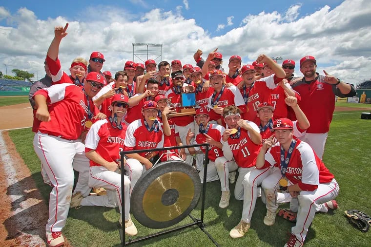 The Souderton baseball team poses with the trophy after winning the PIAA Class 6A championship.