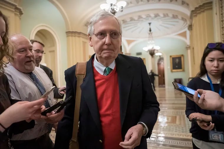 Senate Majority Leader Mitch McConnell, R-Ky., is met by reporters as he arrives at the Capitol on the first morning of a partial government shutdown in Washington, Saturday, Dec. 22, 2018.