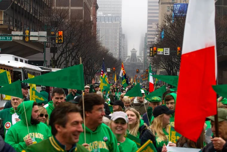 A crowd marches down Market Street during the St. Patrick's Day Parade in Center City, Philadelphia.