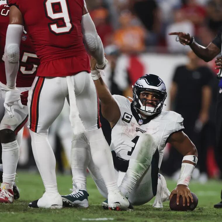 Philadelphia Eagles quarterback Jalen Hurts (1) is helped up after a sack in the fourth quarter of the game against the Tampa Bay Buccaneers in Tampa, Fla., on Monday, Sept. 25, 2023.
