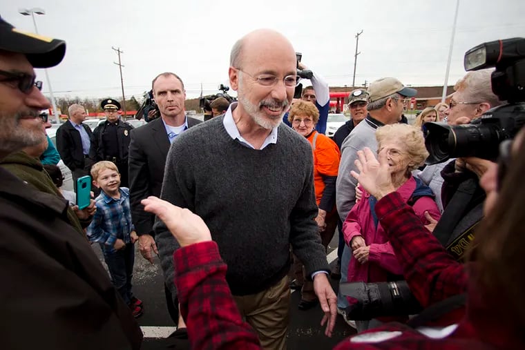 Pennsylvania Democratic Gov.-elect Tom Wolf meets with well-wishers outside the Manchester Cafe the day after he won the gubernatorial election, Wednesday, Nov. 5, 2014, in Manchester, Pa. Wolf won nearly 55 percent of the vote in Tuesday's election, making Republican Tom Corbett the first Pennsylvania governor to be denied a second term. (AP Photo/Matt Rourke)
