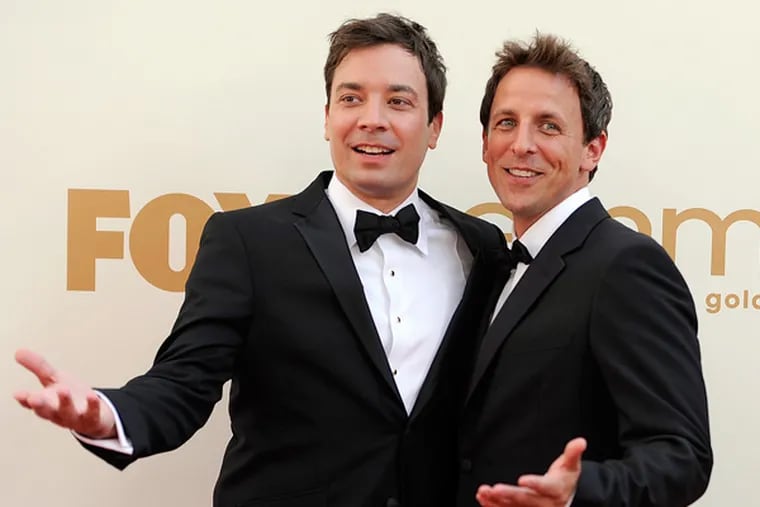 This file photo shows Jimmy Fallon, left, and Seth Meyers at the 63rd Primetime Emmy Awards in Los Angeles. Meyers is moving from his "Weekend Update" desk to his own late night show on NBC. (AP Photo/Chris Pizzello, file)