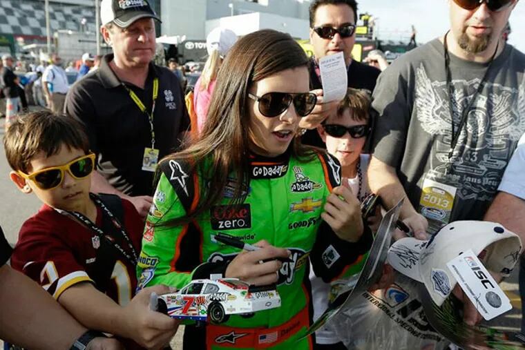 Danica Patrick signs autographs for fans after her qualifying run for
Saturdays NASCAR Nationwide Series auto race, Friday, Feb. 22, 2013,
at Daytona International Speedway in Daytona Beach, Fla. (Chris O'Meara/AP)