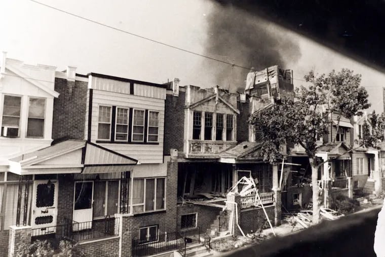 42 seconds after the drop, the bomb explodes on the roof of the MOVE house followed by secondary explosions and a fire.