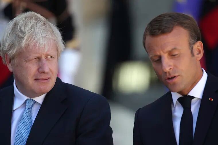 Britain's Prime Minister Boris Johnson looks across at French President Emmanuel Macron at the Elysee Palace, Thursday, Aug. 22, 2019 in Paris. Boris Johnson traveled to Berlin Wednesday to meet with Chancellor Angela Merkel before heading to Paris to meet with French President Emmanuel Macron.