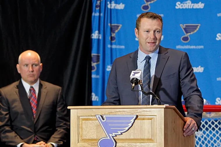 Saint Louis Blues general manager Doug Armstrong (left) looks on as Martin Brodeur addresses the media during a press conference at Scottrade Center. (Scott Kane/USA TODAY Sports)