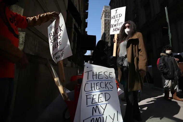 Michelle Perry, of Center City, protests outside Gov. Wolf's Philadelphia office on March 10 at a rally to "demand Governor Wolf act to provide a working unemployment system to provide timely responses and benefits to unemployed workers."