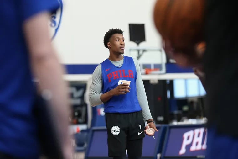 The Sixers' Josh Richardson talks to teammates after practice at the Sixers Training Complex in Camden, N.J., on Wednesday, Feb. 19, 2020.