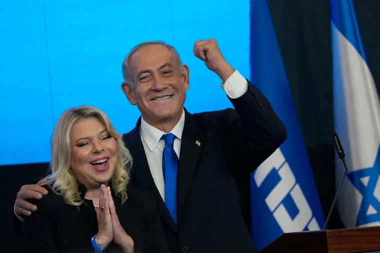 Former Israeli Prime Minister and the head of Likud party Benjamin Netanyahu and his wife, Sara, react after first exit-poll results for the Israeli Parliamentary election at his party's headquarters in Jerusalem on Wednesday.