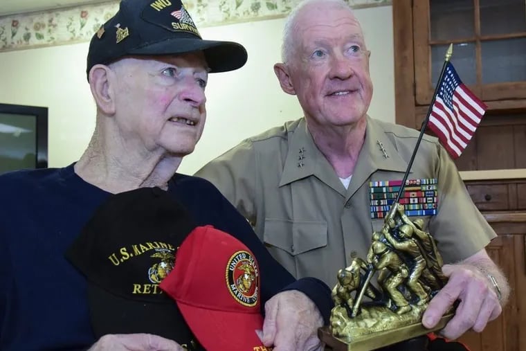 Retired Marine Lt. Gen. Richard Mills (right) presented a statue of the Marines raising the American flag at Iwo Jima to World War II combat veteran Louis Rittelmann.