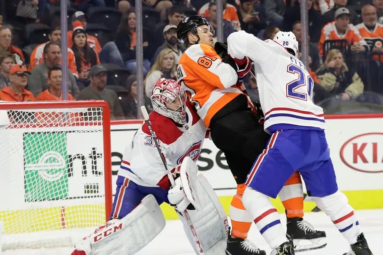 Flyers left winger Carsen Twarynski getting sandwiched between Montreal Canadiens defenseman Cale Fleury (right) and goaltender Carey Price during a game early in the 2019-20 season.