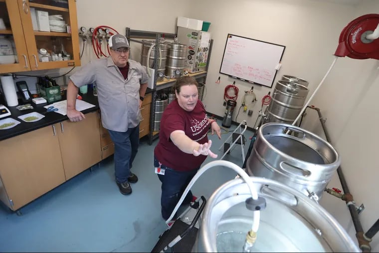 Grad student Dave MacKenzie, 60, and Marisa Egan, 37 beer manager and instructor brew at the McNeil Science and Tech center at University of the Sciences in Philadelphia Wednesday June 20,