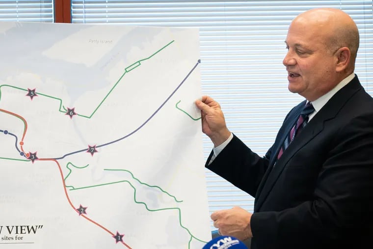 Camden County Freeholder Jeffrey Nash displays a map detailing the locations where illegal dumping sites will be transformed into public art spaces through a $1 million grant.