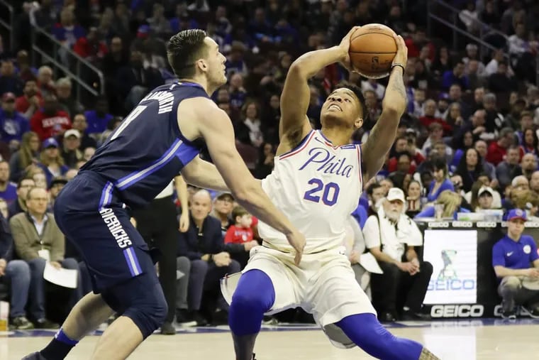 Sixers guard Markelle Fultz brings the ball up as he drives to the basket against Dallas Mavericks guard Kyle Collinsworth.