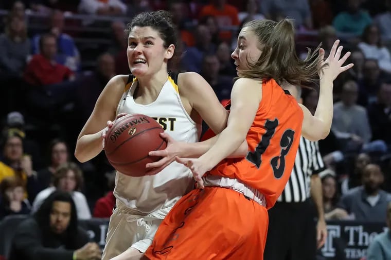 Emily Spratt, left, of Central Bucks West drives to the basket against Mary Miller of Pennsbury in the District 1 Class 6A girls basketball championship.