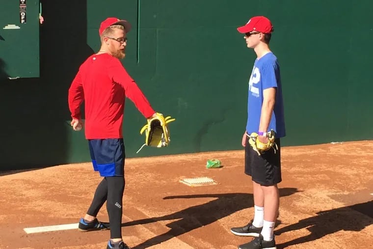 Washington reliever Sean Doolittle works with Shawnee senior Danny Hill in Nationals bullpen after recent game.