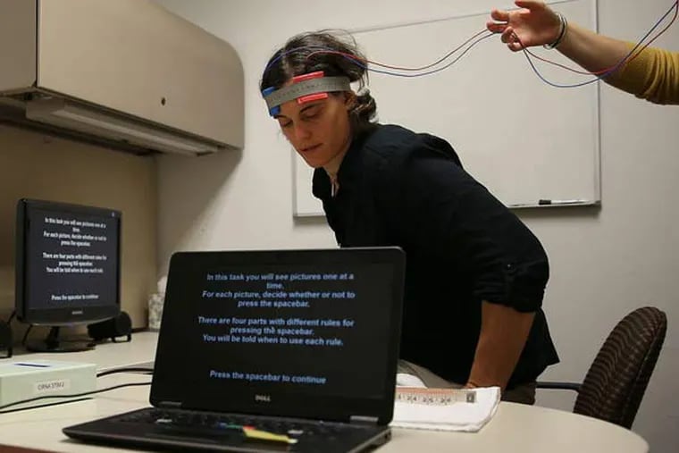 The transcranial direct current brain stimulation test developed by Penn researcher Caryn Lerman is demonstrated by Becky Ashare.