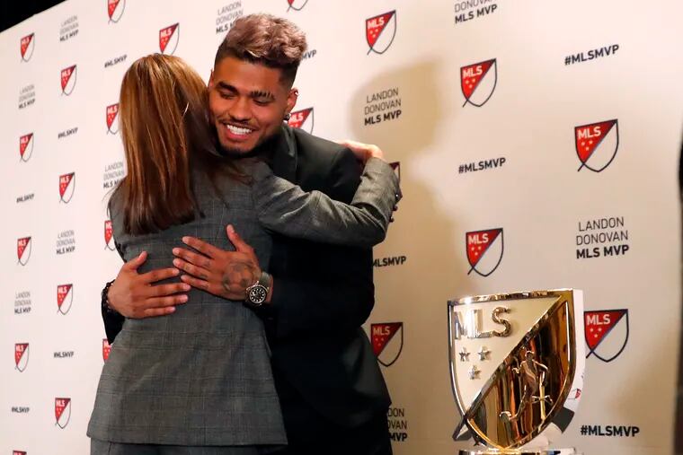 Atlanta United's Josef Martinez is embraced by Angie Blank, wife of team owner Arthur Blank, after receiving this year's MLS MVP award.