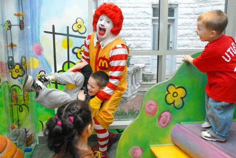 Joey Slawter, 6, of Warrington, clowns around with Ronald McDonald at the West Philadelphia house while Joey's 3-year-old brother, Andrew, laughs at the scene.