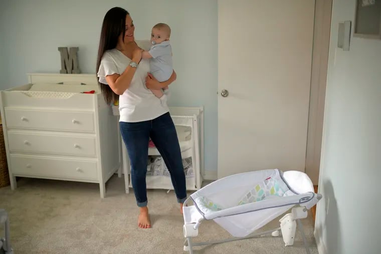 Miana Tompkins holds her 4-month-old son, Mason, in his bedroom at home in Alexandria, Va. She stopped using the Fisher-Price Rock 'n Play sleeper after the recall.